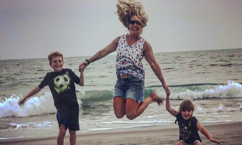 Mom and Kids Jumping on the beach