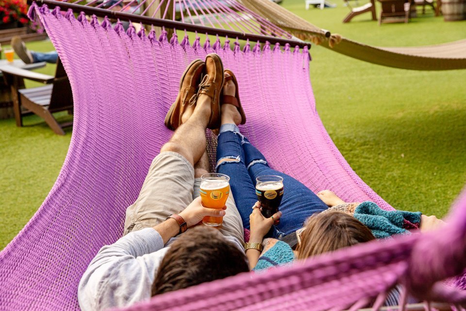couple in hammock with beer