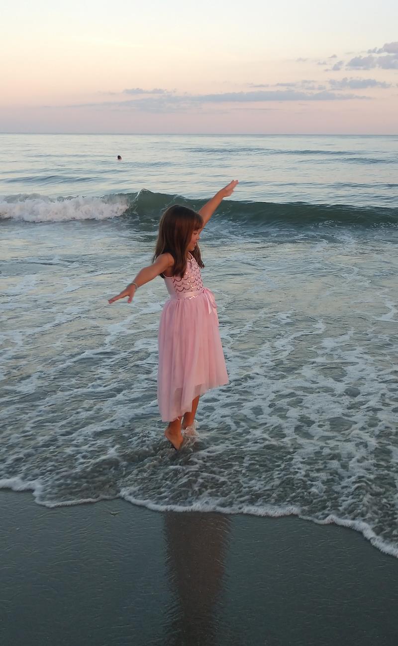 little girl on beach at sunset