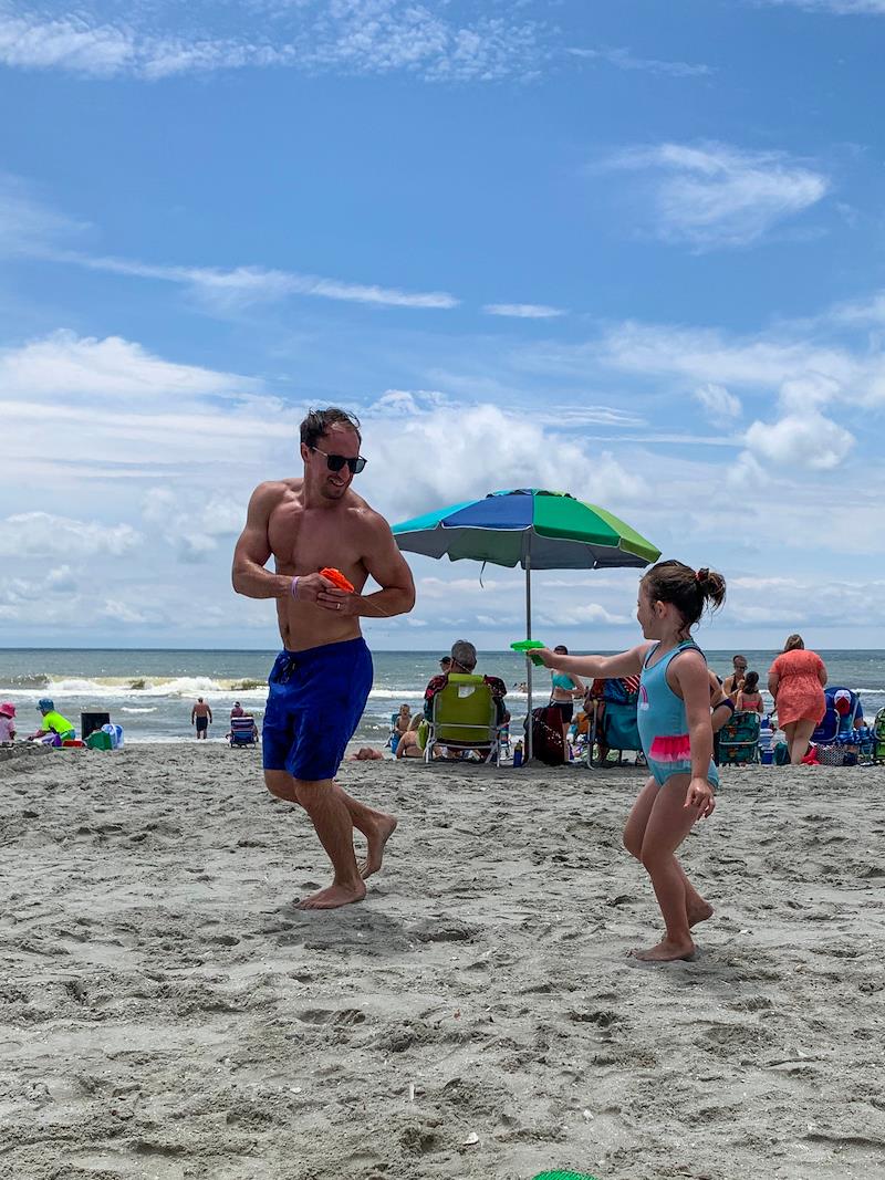 dad playing waterguns with daughter