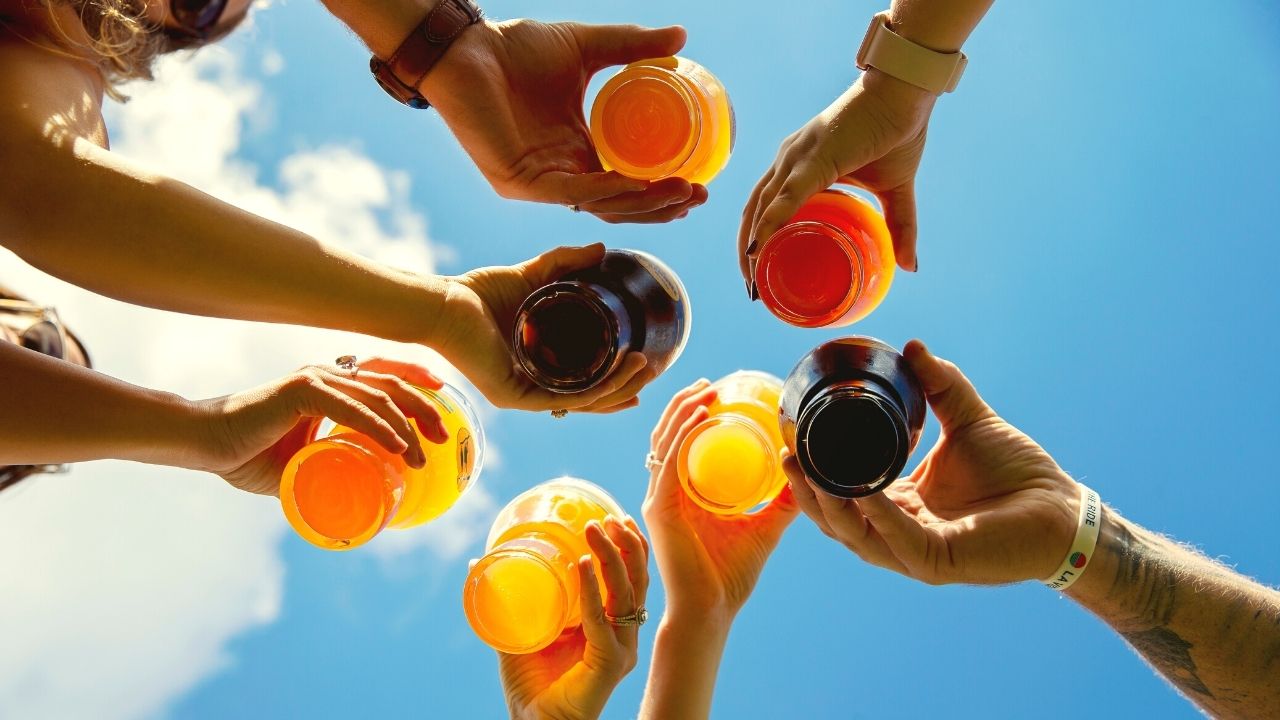 Group of people clinking beer glasses