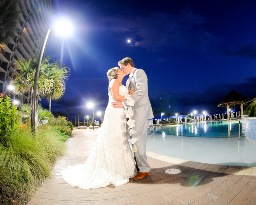 Bride and Groom Kissing on Pool Deck