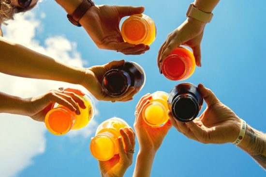 Group of people clinking beer glasses