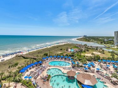 Balcony view of coastline and the pool deck at North Beach