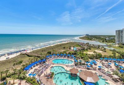 Balcony view of coastline and the pool deck at North Beach