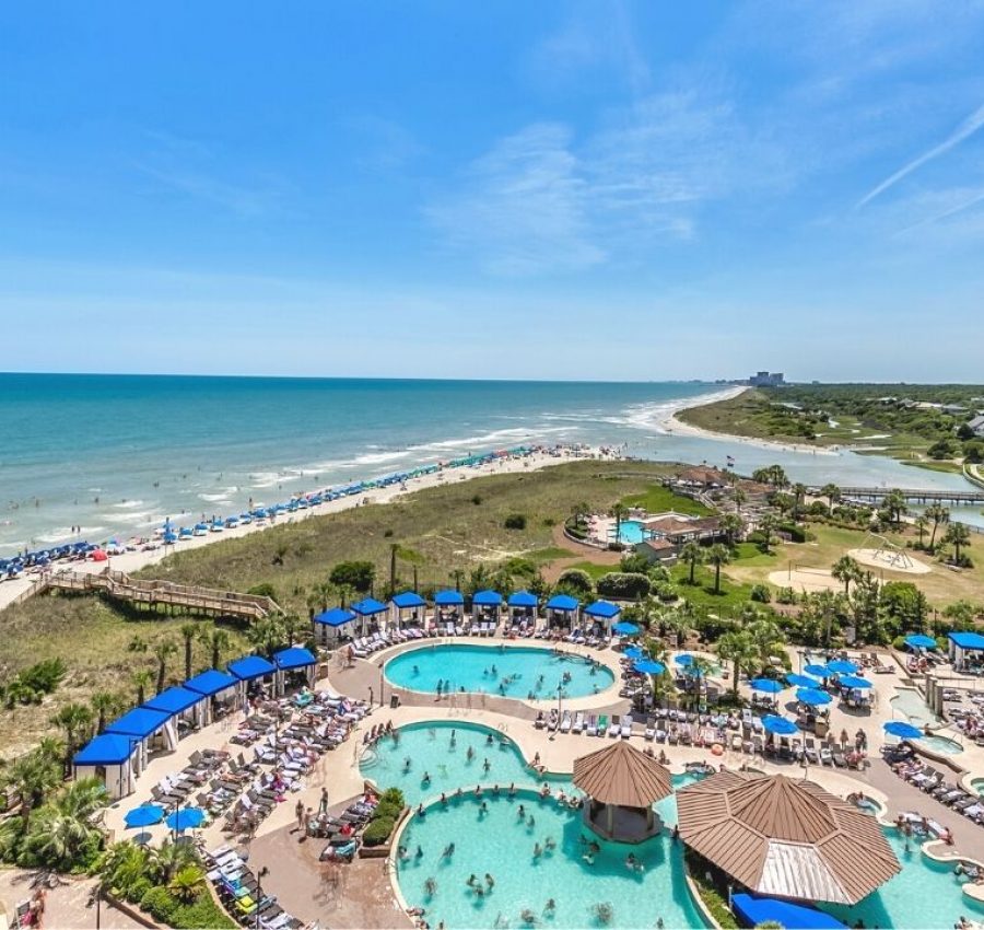 Balcony view of coastline and the pool deck at North Beach