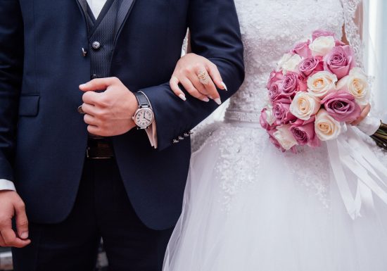 couple getting married with bouquet of flowers